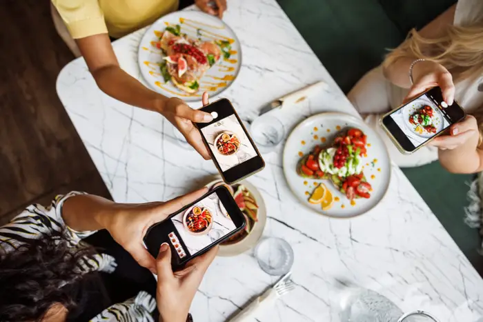 Food influencer capturing a restaurant dish